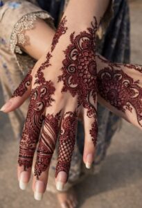 an intricate back‑hand mehndi pattern featuring…